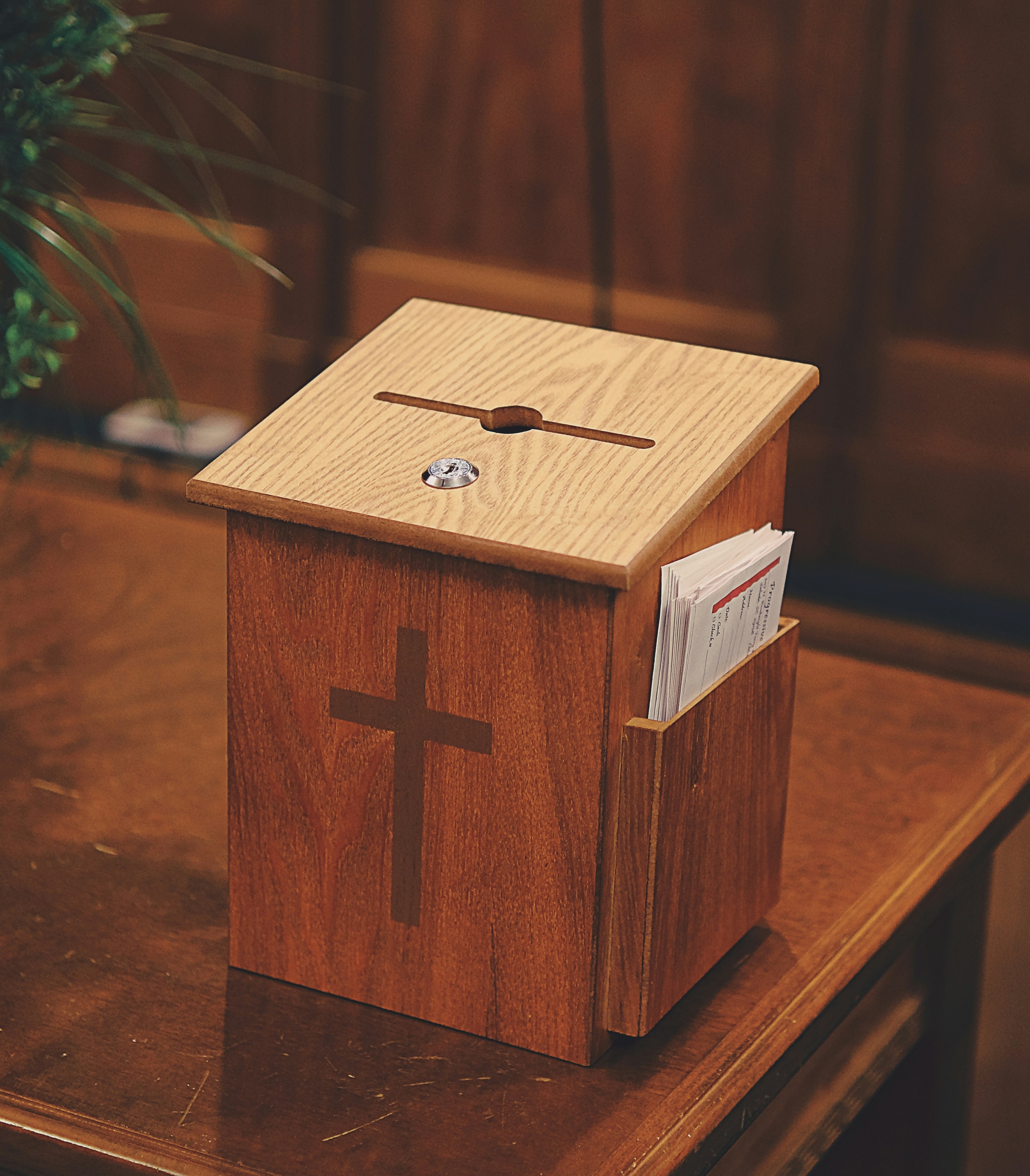 Church offering envelopes and pen placed on a wooden table
